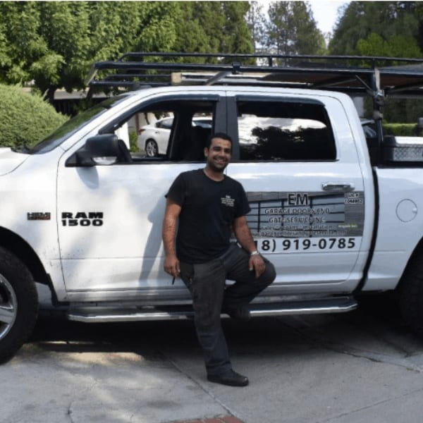 Technician fixing automatic garage and gate system in LA
