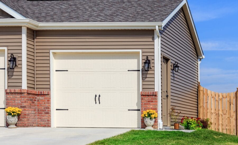 Modern suburban house with a two-car garage and well-maintained landscaping in clear daylight