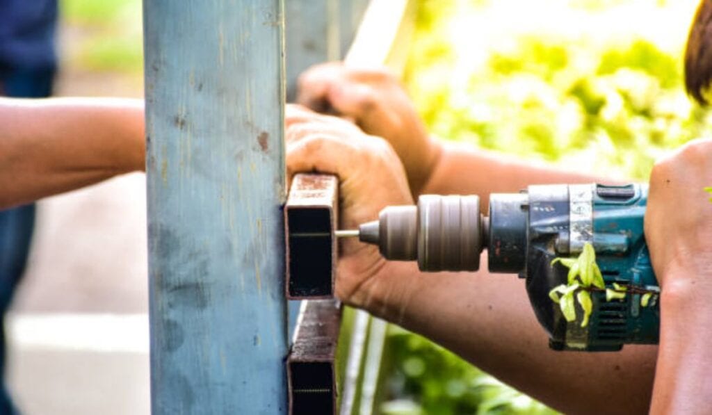 HOA community entrance gate with well-maintained posts, tracks, and fencing
