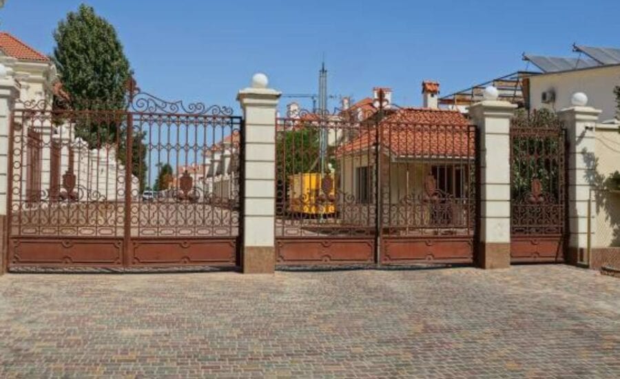Electric gate motor being cleaned during standard maintenance