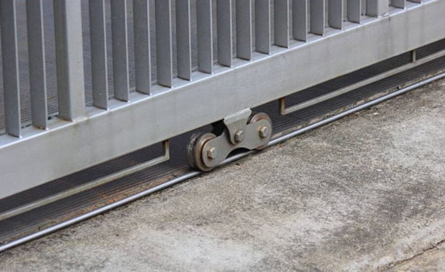 Worker tightening screws on a residential swing gate
