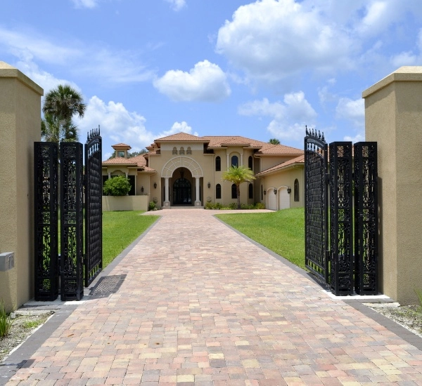 Residential driveway gate repair at a modern home in a sunny neighborhood