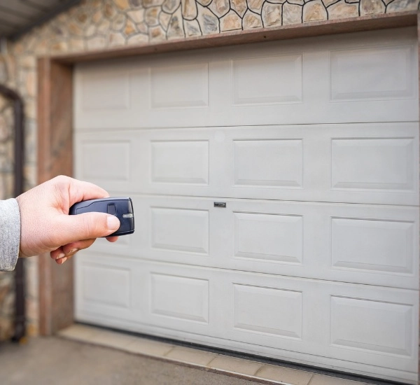 Remote control garage door opening at a residential home during the day
