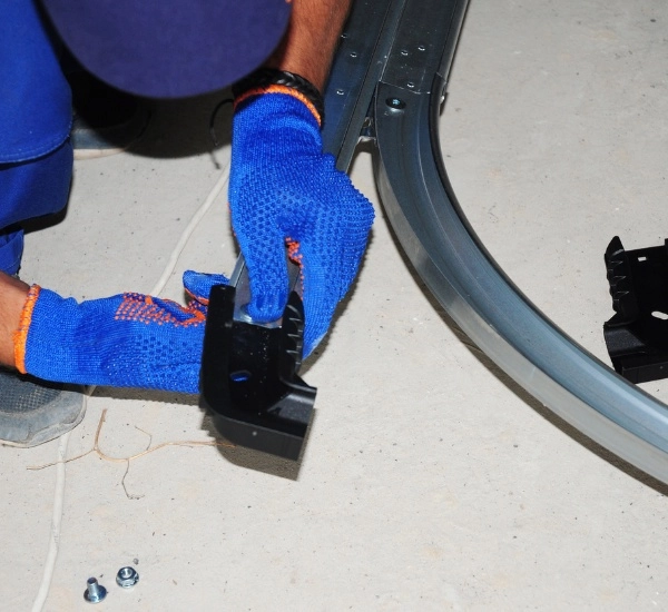 Individual assembles car parts in workshop using specialized tools during afternoon session focused on automotive maintenance and repair