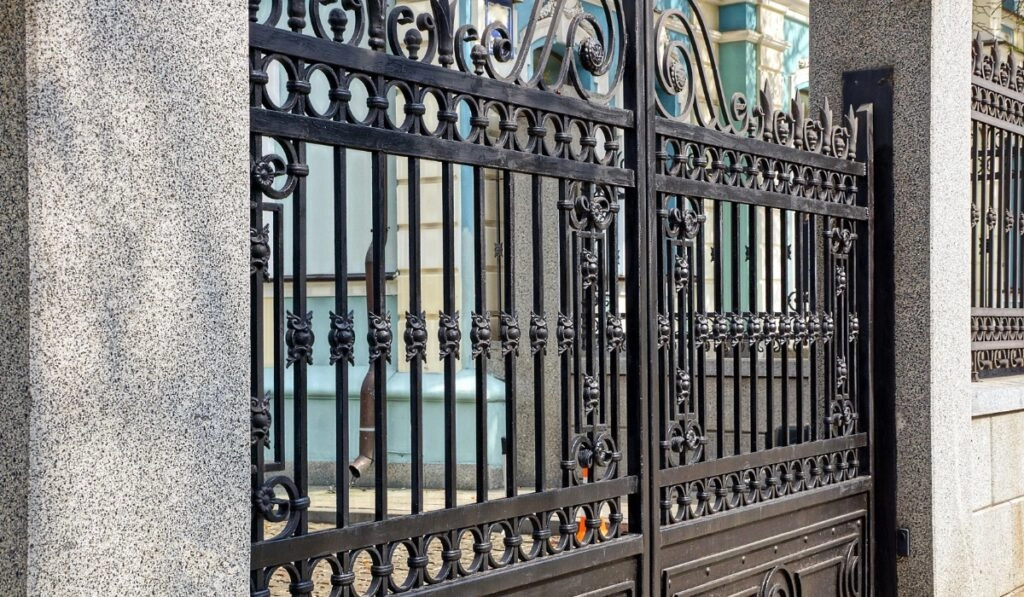 Elegant wrought iron gate design at a historic building entrance in the early morning light