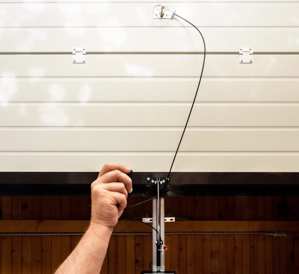 Installing a pull cord for easy operation of a garage door on a sunny afternoon in a well-maintained garage