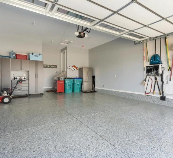Spacious residential garage featuring organized storage and clean flooring in a suburban neighborhood