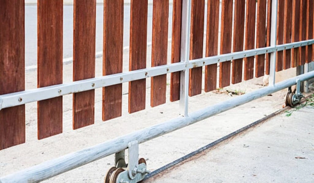 Technician performing routine maintenance on a metal gate